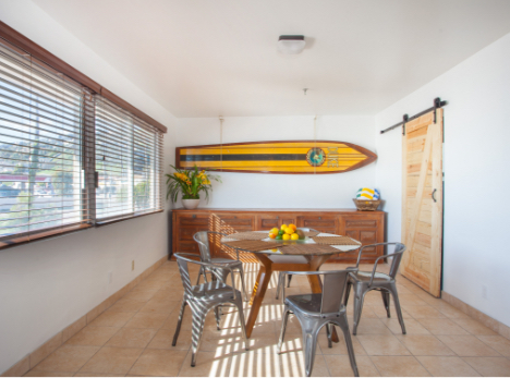 Dining area with surfboard hanging on the wall