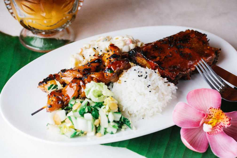 photo of a chicken lunch plate with a cocktail and flower